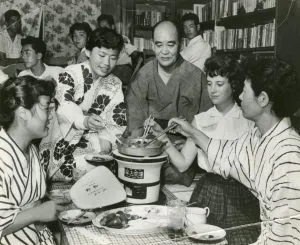 AA Participant Katharine Lowry sharing a sukiyaki dinner with her host family in Japan. 1957.