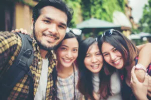 Group of friends taking selfie in a urban street having good fun