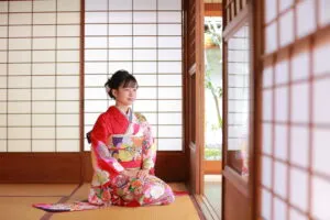 Attractive girl wearing traditional japanese kimono in Japanese-style room in kyoto, Japan.