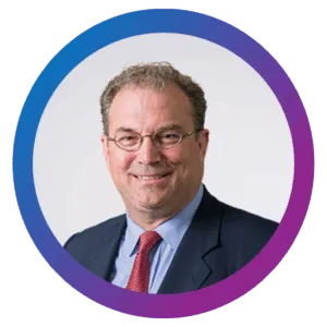 John T. Colas headshot on a blue-purple gradient circle frame.