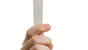 Auction paddle or voting card in hand
