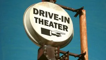 aged and worn vintage photo of drive in theater sign