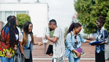 Group of five african college students spending time together on