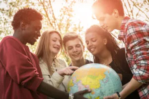 Multiracial Teen Couple Holding Globe Map