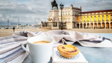 cafe with pasteles de nata and view of famous Lisbon Commerce Square, Portugal