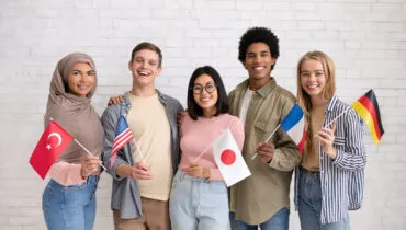 Multiethnic young students with flags of different countries ready to study