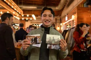 Alum holding up photos from his exchange year