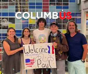 Family with welcome sign