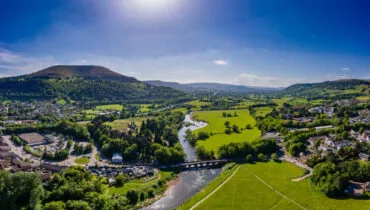 Aerial view of the River Usk and rural Welsh town of Abergavenny, Monmouthshire