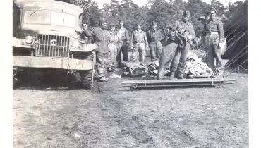 Copy of C Platoon ambulance, Bergen-Belsen concentration camp, 1945. Refugees operating a human laundry to clean up camp inmates. Photograph by Ford