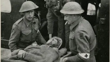 Richard-Bayly-Winder-IV-helping-to-load-a-wounded-soldier-on-a-stretcher1