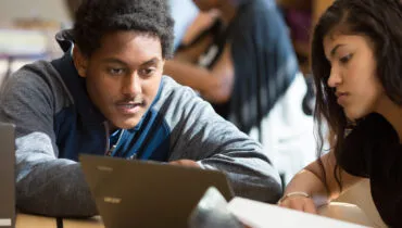 High school boy and girl at computer
