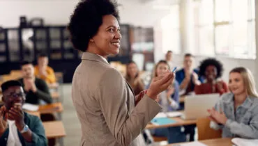 happy-professor-teaching-in-front-of-students