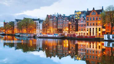 Night city view of Amsterdam, the Netherlands with Amstel river