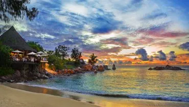 Cafe on tropical beach at sunset
