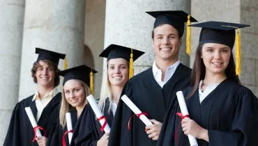 Portrait of graduates posing in single line